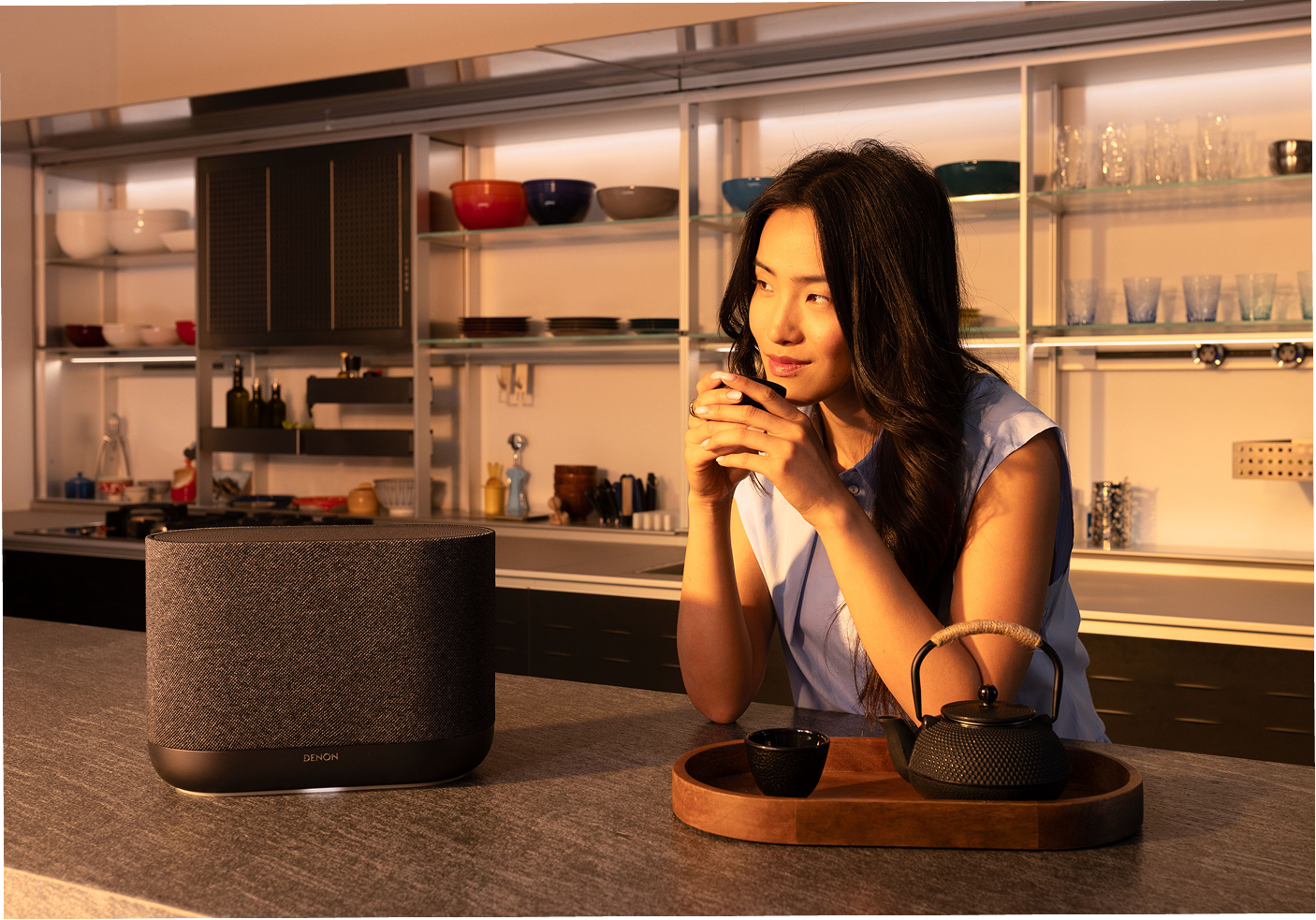 Denon Home 400 wireless speaker in black on a kitchen countertop